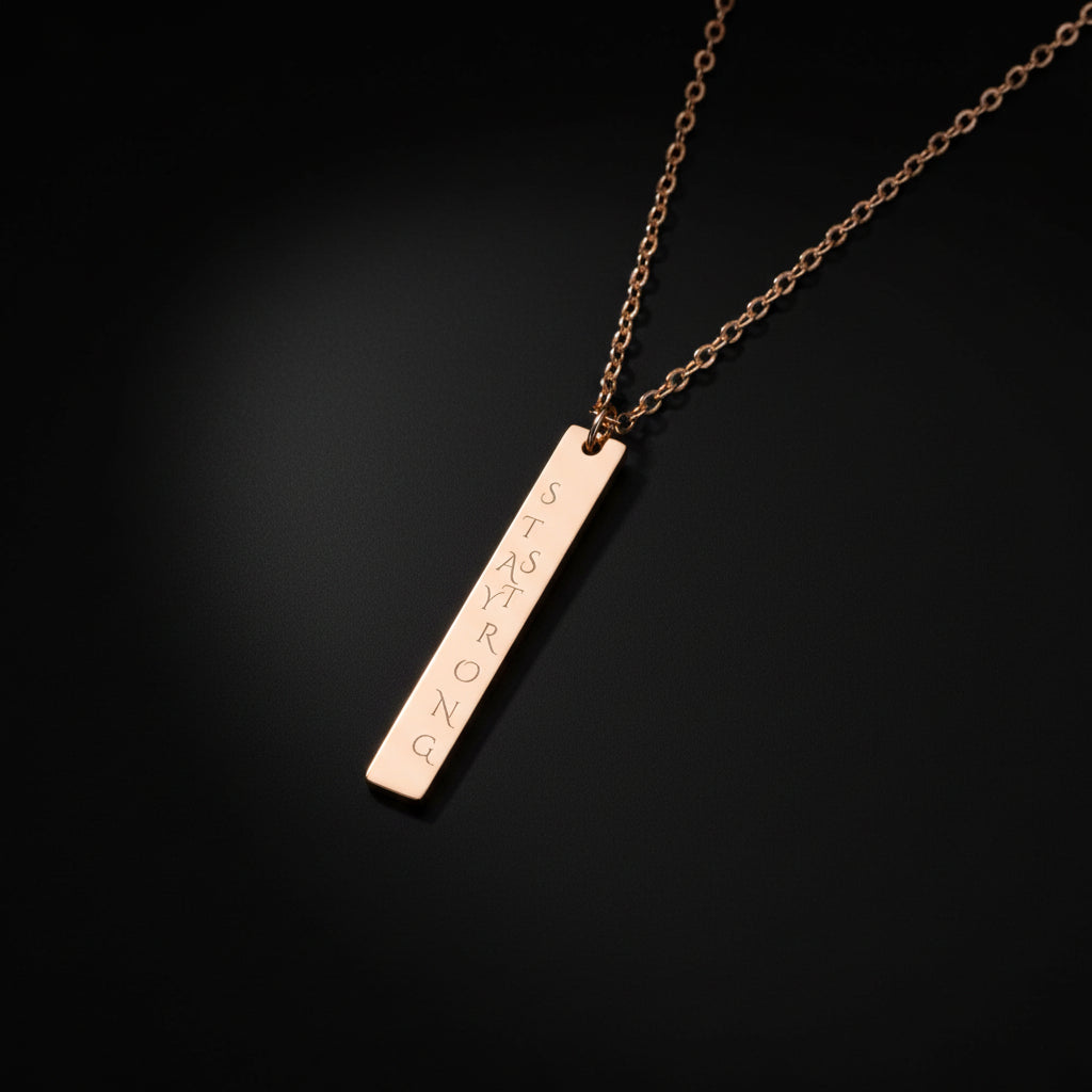 Rose gold necklace with a bar pendant engraved with 'Stay Strong' on a white background Hadi Craft USA