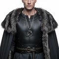 Odin raven pendant necklace worn by a man in a dark cloak with a fur collar, showcasing Viking-inspired style.