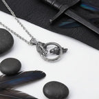 Odin raven pendant necklace featuring Huginn and Muninn design on a stainless steel chain with black stones and feathers.