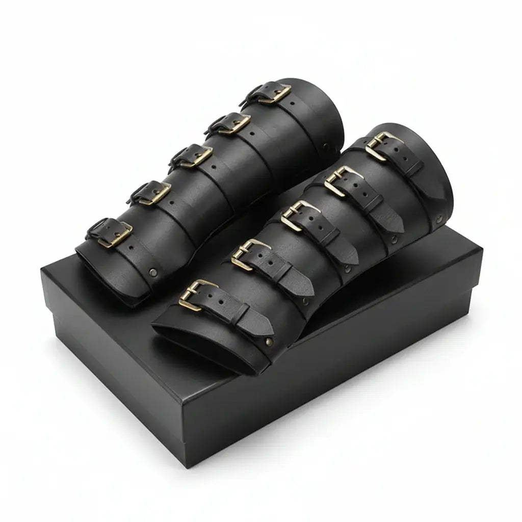 Viking leather bracers for cosplay displayed on a black box, featuring buckled design and medieval style.