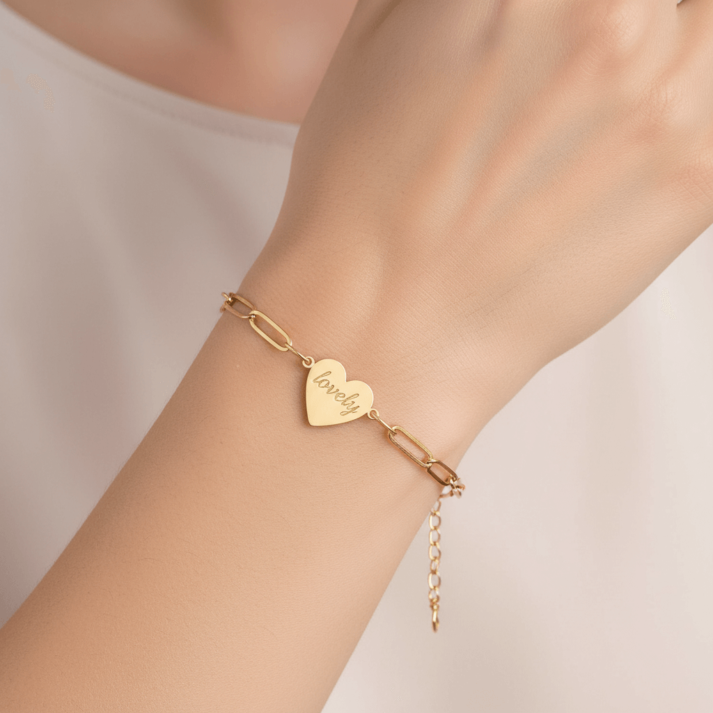 Alt Tag: Engraved paperclip heart bracelet – Engraved Heart Charm Chain in gold on wrist, personalized heart charm, Hadi Craft USA bracelet, engraved jewelry