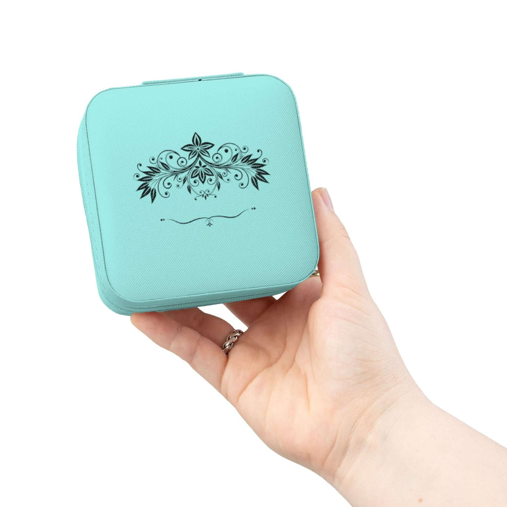 Compact pink jewelry travel organizer held by a hand, featuring a beautiful floral design on a stylish storage box.