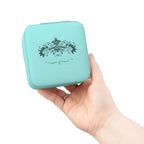 Compact pink jewelry travel organizer held by a hand, featuring a beautiful floral design on a stylish storage box.