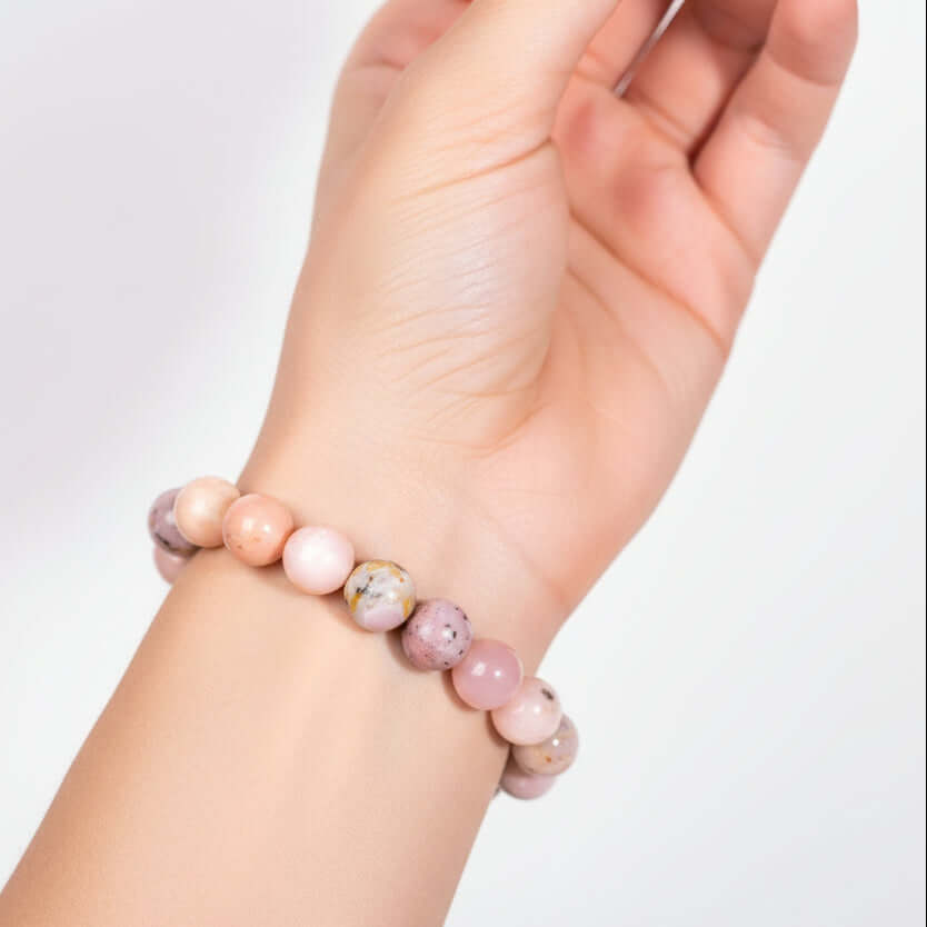 Repair My Heart - The Peruvian Pink Opal Bracelet on wrist, handmade beaded bracelet by Hadi Craft USA, pink opal jewelry